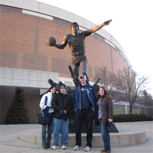 The students admitted they felt like they were betraying Penn State a bit by taking a photo by the Magic Johnson statue outside the Breslin Student Events Center. Photo courtesy of Shubha Kashyap.