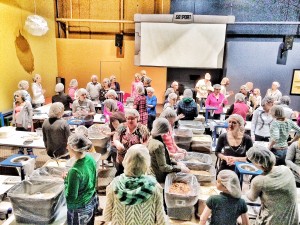 Volunteers packing gift bags for "Feed My Starving Children"