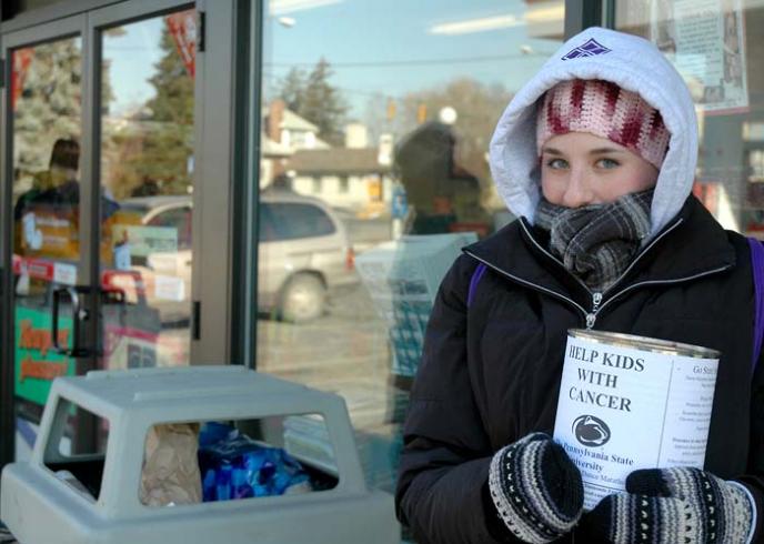 A THON volunteer shows her commitment by collecting donations on a cold winter day (Photo by Katherine Wahler)