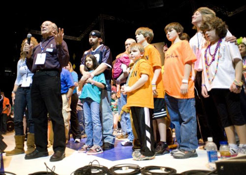 Christopher's father Charles Millard, founder of the Four Diamonds fund, thanks dancers during the 2010 THON, with THON families behind him on stage. (Photo Credit: Annemarie Mountz)