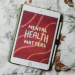 Tablet device with text reading "Mental Health Matters" on screen