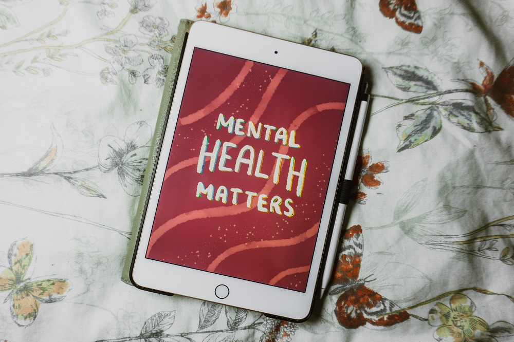 Tablet device with text reading "Mental Health Matters" on screen
