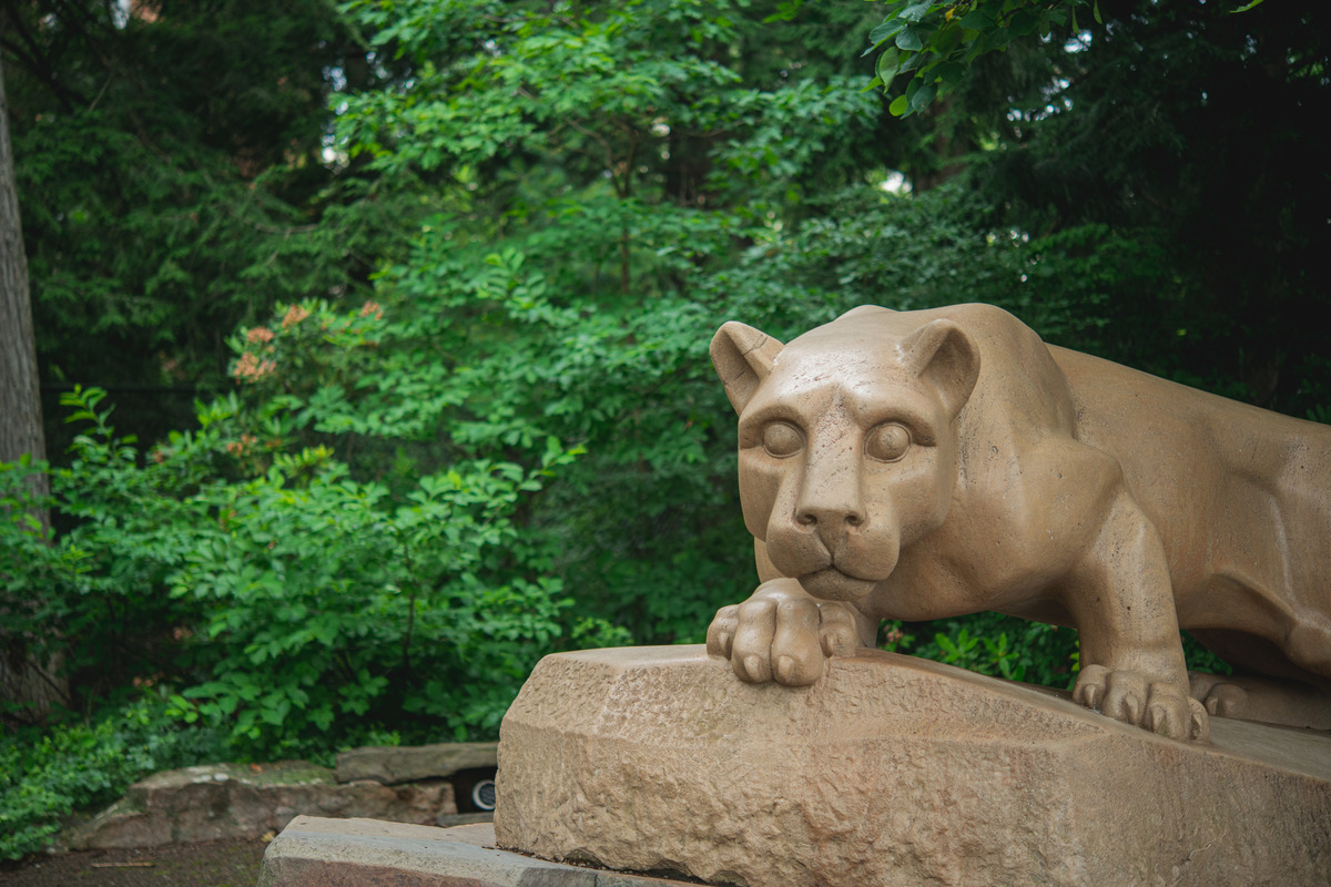 Nittany Lion Shrine with green trees in background