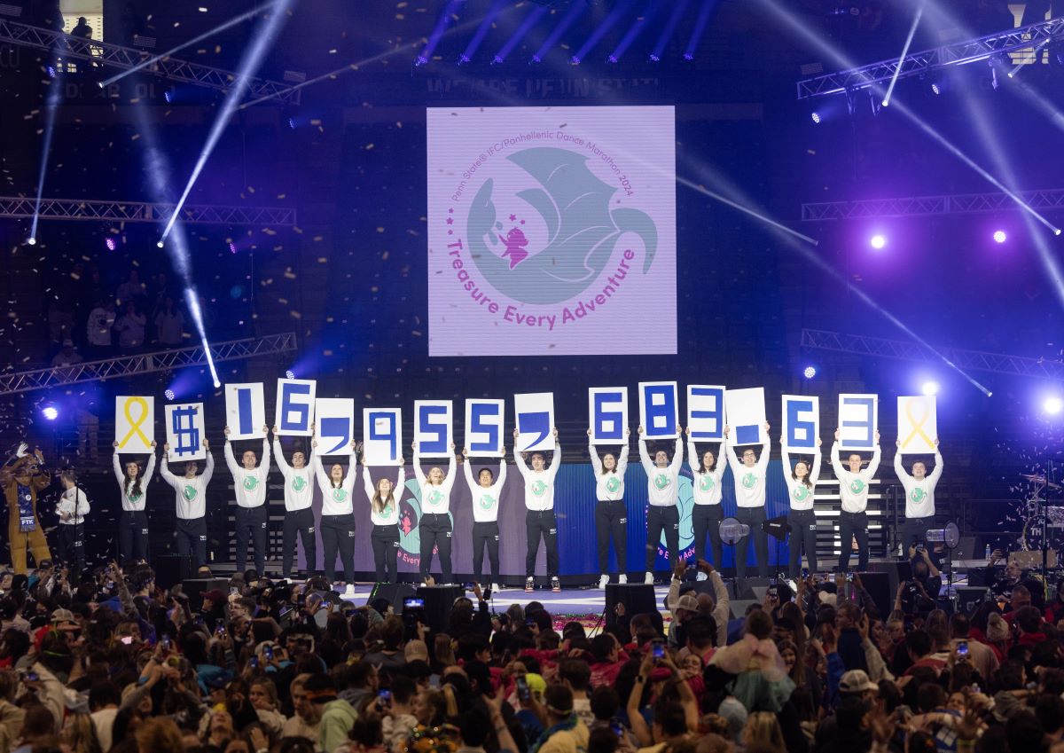 Conclusion of THON with dancers holding up cards signifying the total raised.